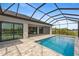 Enclosed pool and patio area with water view at 15004 Alsask Cir, Port Charlotte, FL 33981