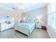 Large bedroom with a king-size bed, nightstands, and a ceiling fan at 1540 San Ysidro Way, Venice, FL 34285