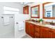 Elegant bathroom featuring double vanities, granite countertops, and decorative bronze hardware at 172 Southampton Pl # 346, Venice, FL 34293