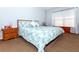 Comfortable bedroom with patterned bedding, matching nightstand, and a window for natural light at 172 Southampton Pl # 346, Venice, FL 34293