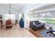 Open-concept dining room leading to a sunroom with neutral couches and lots of bright, natural light at 172 Southampton Pl # 346, Venice, FL 34293