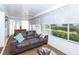 Bright living room showcases large windows, a plush sofa, and scenic outdoor views at 172 Southampton Pl # 346, Venice, FL 34293