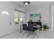 Modern dining area with glass table, four black chairs, and large window at 200 Gardens Edge Dr # 212, Venice, FL 34285