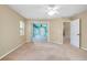 Bright bedroom with access to patio, neutral walls, and ceiling fan at 3888 Candia Ave, North Port, FL 34286