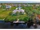 Aerial view of waterfront home with private dock and lush green lawn at 4646 Fallon Cir, Port Charlotte, FL 33948