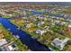 Wide aerial view of a waterfront community with canals and houses at 4646 Fallon Cir, Port Charlotte, FL 33948