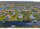 Aerial view of a waterfront home with private dock and surrounding community at 4646 Fallon Cir, Port Charlotte, FL 33948