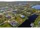 Aerial view showcasing a neighborhood with water access and various houses at 4646 Fallon Cir, Port Charlotte, FL 33948