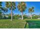 Grass, palm trees and private dock access to the canal at 4646 Fallon Cir, Port Charlotte, FL 33948