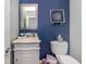 Small bathroom with a pedestal sink and decorative mirror at 514 Palm Ave, Nokomis, FL 34275