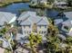 Two-story waterfront home with metal roof and palm trees at 737 Shakett Creek Dr, Nokomis, FL 34275