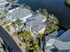 Waterfront home with gray metal roof and palm trees at 737 Shakett Creek Dr, Nokomis, FL 34275