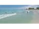 Beach scene with people swimming and sunbathing at 737 Shakett Creek Dr, Nokomis, FL 34275