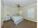 Bright bedroom with carpeted floors, featuring a queen-size bed and two nightstands at 737 Shakett Creek Dr, Nokomis, FL 34275