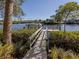 Wooden walkway leads to a private boat dock at 737 Shakett Creek Dr, Nokomis, FL 34275