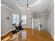 Bright exercise room with hardwood floors and Peloton bike at 737 Shakett Creek Dr, Nokomis, FL 34275