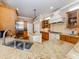 Modern kitchen with double sink, granite countertops, and custom cabinetry at 737 Shakett Creek Dr, Nokomis, FL 34275