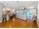 Open concept kitchen and living area with hardwood floors and island seating at 737 Shakett Creek Dr, Nokomis, FL 34275