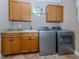 Laundry room with washer, dryer, cabinets and granite countertop at 737 Shakett Creek Dr, Nokomis, FL 34275