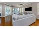 Bright living room featuring hardwood floors, a sectional sofa, and stunning water views at 737 Shakett Creek Dr, Nokomis, FL 34275