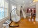 Living room with hanging chair and hardwood floors at 737 Shakett Creek Dr, Nokomis, FL 34275