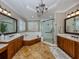 Main bathroom with double vanity, soaking tub and walk-in shower at 737 Shakett Creek Dr, Nokomis, FL 34275