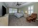 Spacious main bedroom with large windows, a ceiling fan and comfortable seating at 737 Shakett Creek Dr, Nokomis, FL 34275