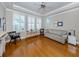 Home office with hardwood floors, a comfortable couch, and built-in shelving at 737 Shakett Creek Dr, Nokomis, FL 34275