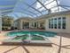 Inviting pool area with a screened enclosure and a relaxing fountain at 7551 Conservation Ct, Sarasota, FL 34241