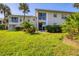 Grassy backyard with a patio area, perfect for outdoor dining and relaxation at 804 Montrose Dr # 103, Venice, FL 34293