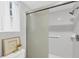 Bright bathroom featuring a tiled shower with sliding glass doors and decorative accents at 804 Montrose Dr # 103, Venice, FL 34293