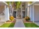 Inviting building entrance with well-manicured landscaping and stairs leading to upper units at 804 Montrose Dr # 103, Venice, FL 34293