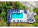 Aerial view of a community pool with lounge chairs and well-maintained landscaping at 804 Montrose Dr # 103, Venice, FL 34293