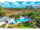 Inviting community pool area surrounded by lush landscaping and comfortable lounge chairs at 804 Montrose Dr # 103, Venice, FL 34293