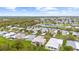 Aerial view of a mobile home community by the water, showing homes and green spaces at 8448 Kinglet Dr, Englewood, FL 34224