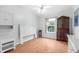 Bright bedroom with white wood furniture and wood-look flooring at 8448 Kinglet Dr, Englewood, FL 34224