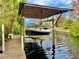 Covered boat lift with a spacious dock at 852 E 6Th St, Englewood, FL 34223