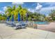 Inviting pool area with patio tables and umbrellas at 93 Inlets Blvd # 93, Nokomis, FL 34275