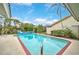 Inviting swimming pool with brick coping and a large patio area at 93 Inlets Blvd # 93, Nokomis, FL 34275