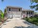 Two-story house with two-car garage and landscaping at 1172 Kenisco Rd, Venice, FL 34293