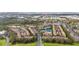 Aerial view of a community with numerous buildings, a pool, and tennis courts at 8315 Glenrose Way # 1414, Sarasota, FL 34238