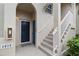 Building entrance with stairs and a blue door at 8315 Glenrose Way # 1414, Sarasota, FL 34238