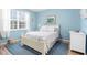 Charming bedroom with light blue walls and a comfortable bed at 8315 Glenrose Way # 1414, Sarasota, FL 34238