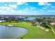 Aerial view of upscale community with golf course, lake, and luxury homes at 804 Montrose Dr # 103, Venice, FL 34293