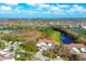 Aerial view of townhomes near a lake and conservation area at 804 Montrose Dr # 103, Venice, FL 34293