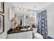 Clean bathroom with granite vanity and blue and white shower curtain at 804 Montrose Dr # 103, Venice, FL 34293