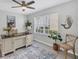Home office with built-in desk and large window overlooking backyard at 804 Montrose Dr # 103, Venice, FL 34293