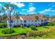 Aerial view of condo building with lake view at 804 Montrose Dr # 103, Venice, FL 34293