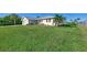 House with metal roof, attached garage and manicured lawn at 4646 Fallon Cir, Port Charlotte, FL 33948