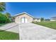 Single-story home with attached garage and well-maintained lawn at 4646 Fallon Cir, Port Charlotte, FL 33948